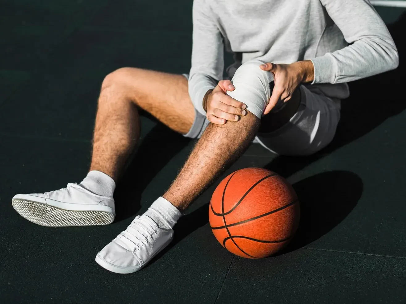 Athlete taping a knee before going back on the court