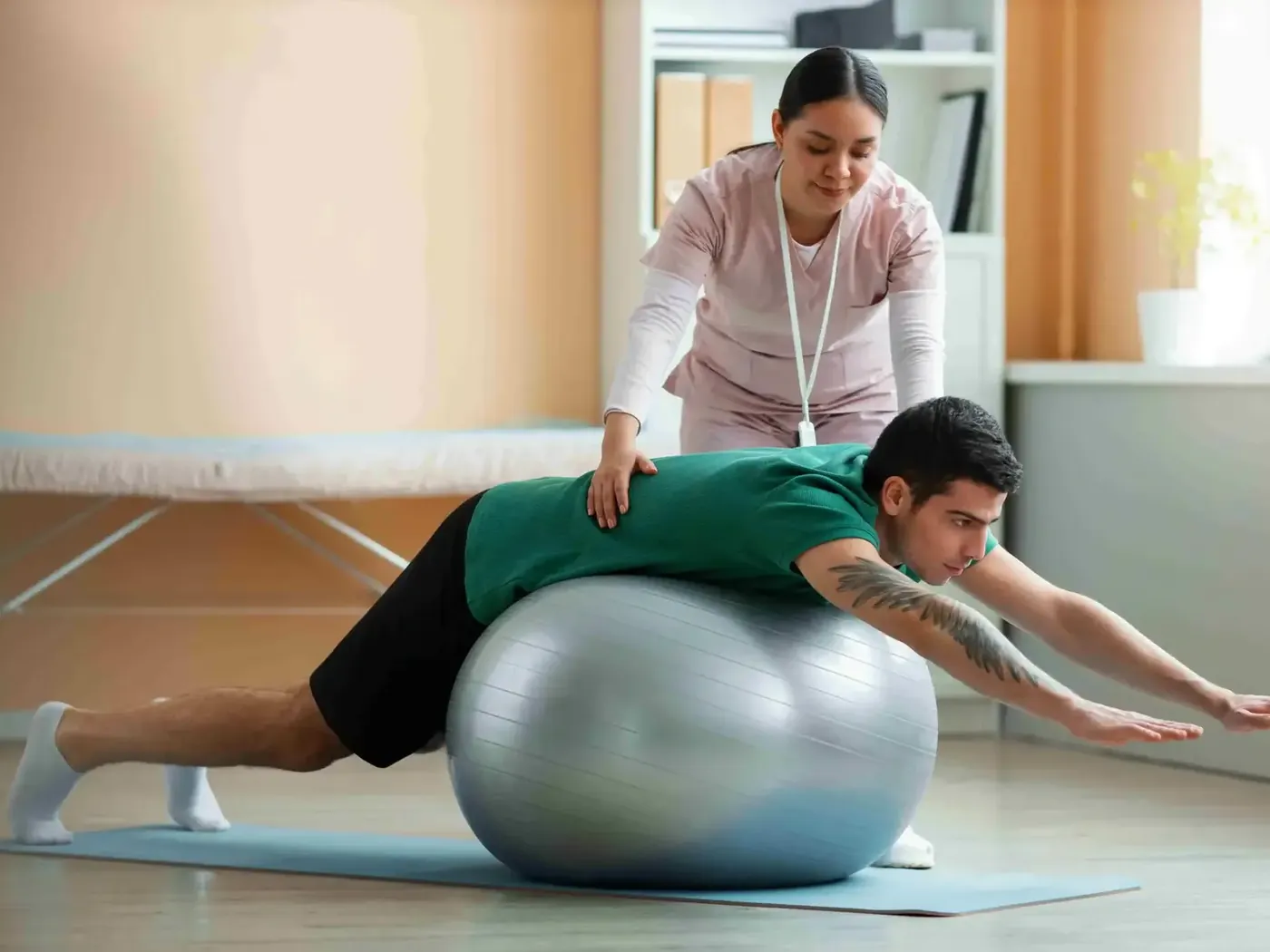 Patient working through guided mobility exercises over a therapy ball