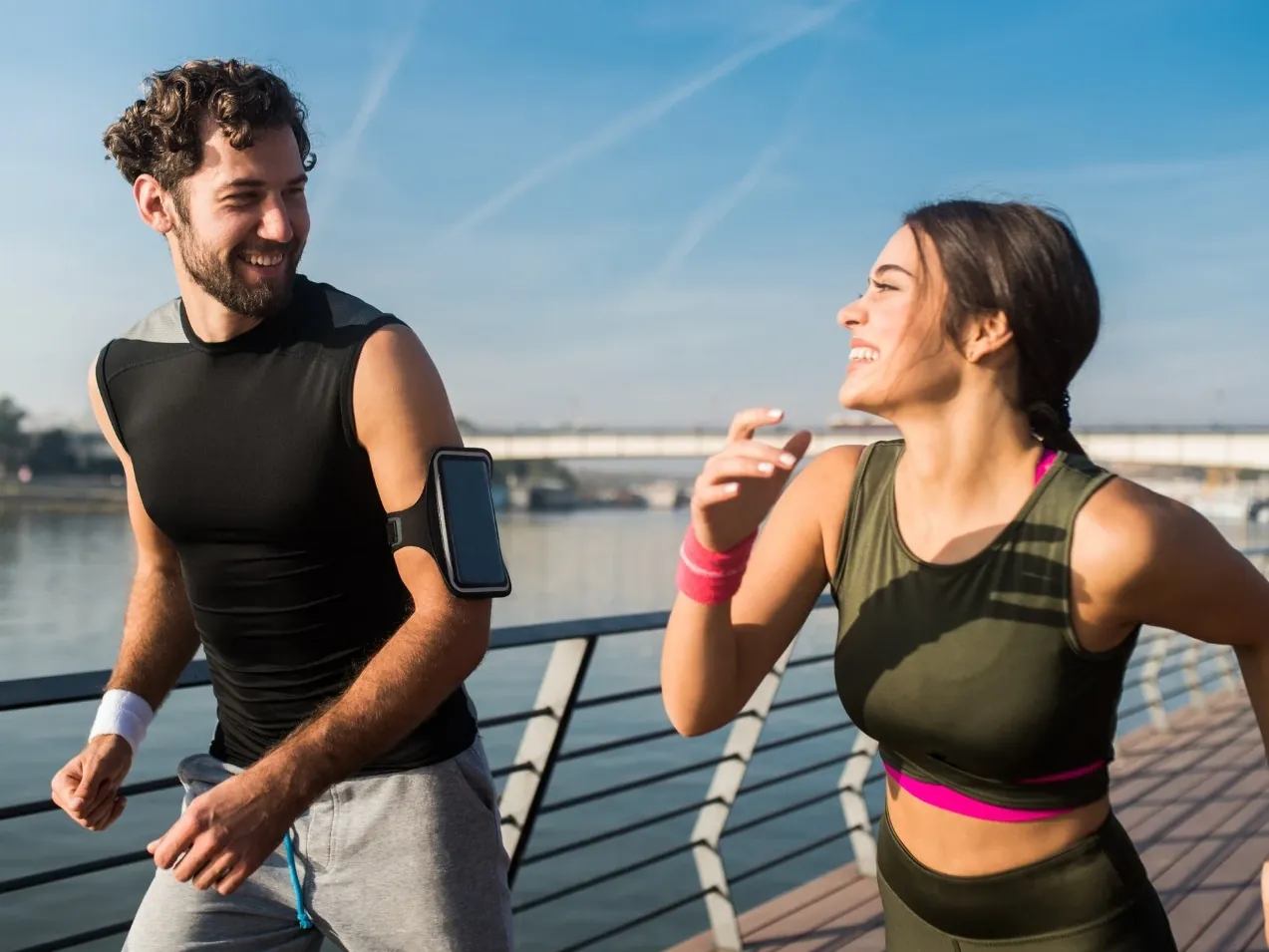 Two people running outdoors, back to full activity