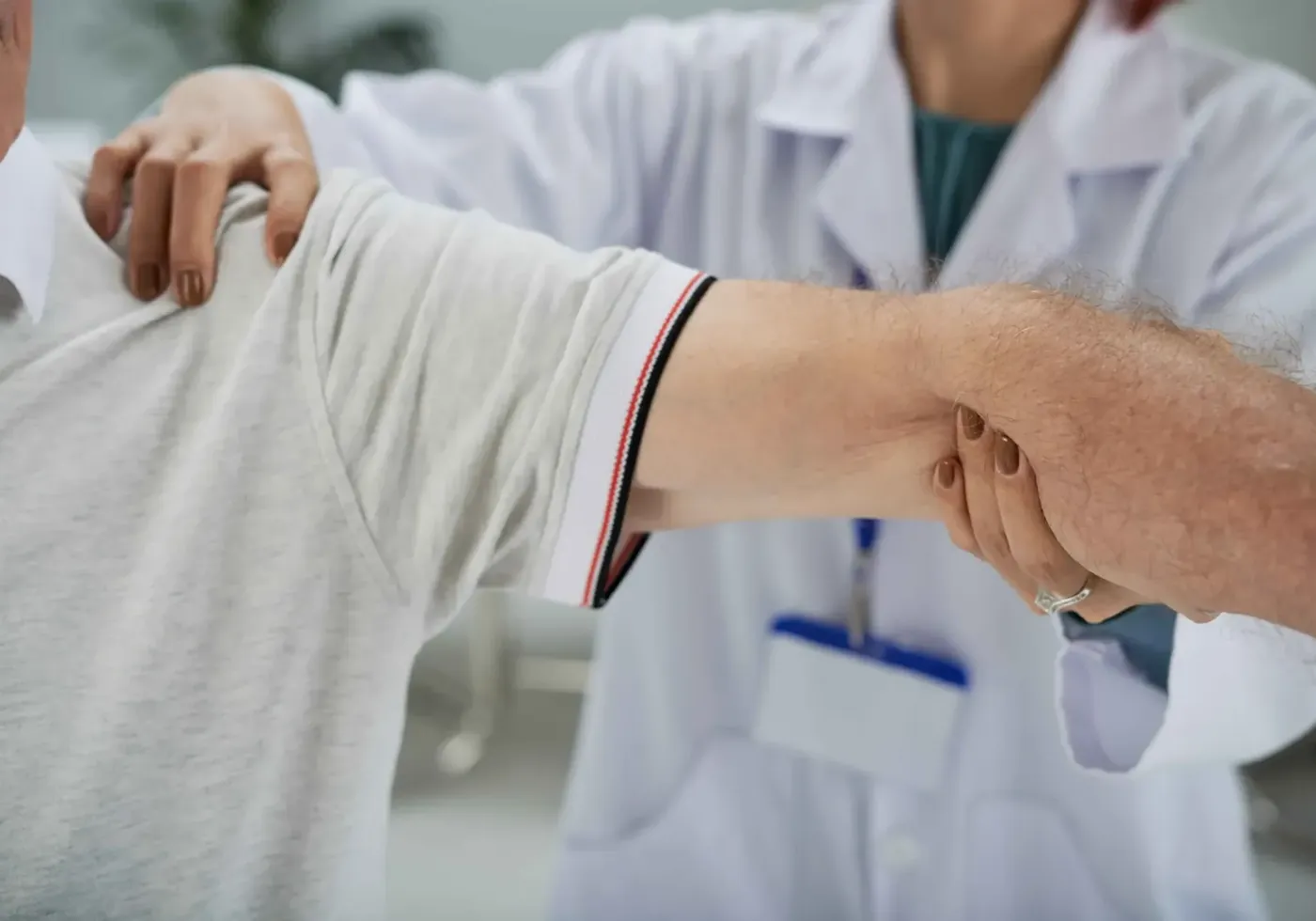 Therapist mobilizing a patient's shoulder joint by hand