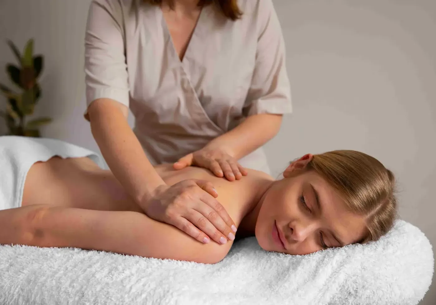 Massage therapy being performed on a patient's back and shoulders
