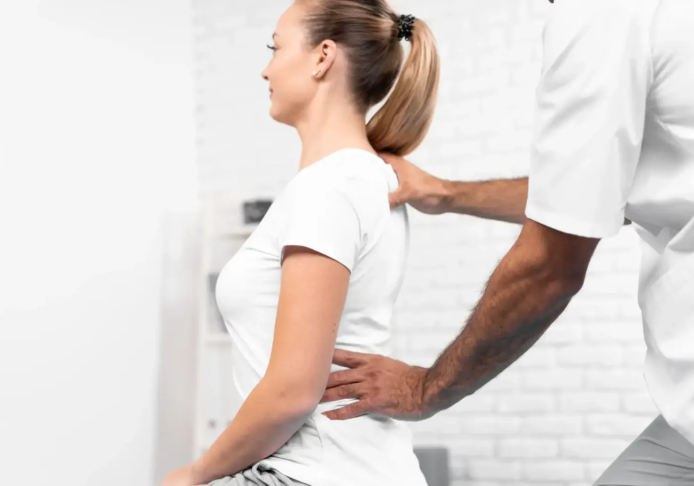Therapist performing a spinal manipulation on a patient's mid back