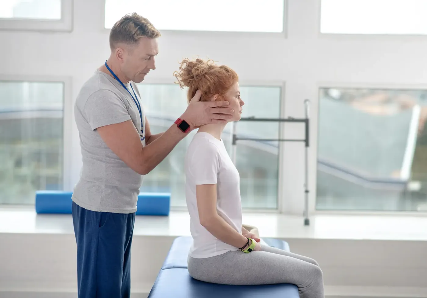 Therapist guiding an older patient through a balance and gaze stability exercise